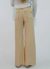 Pantalon de corte recto y tiro medio, confeccionado en gabardina color marrón. Presenta cierre frontal con botón y bolsillos laterales.