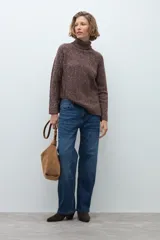 Polerón de cuello alto confeccionado en tejido buclé con textura jaspeada, de corte holgado y mangas largas con diseño raglán.
