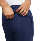 Pantalón de jogging Nike Sportswear Club Fleece, color azul marino, con cintura elástica, puños acanalados en los tobillos y logo de la marca bordado en blanco en la pierna izquierda.