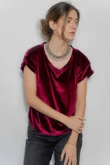 Remera de manga corta confeccionada en terciopelo, con cuello redondo y diseño simple. Una prenda versátil y elegante para elevar cualquier conjunto.