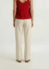 Pantalón recto de mujer en color beige, con cintura elástica y bolsillos frontales aplicados.