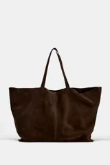 Bolso tipo maxi shopper de serraje marrón, con doble asa de hombro y costura central vertical.