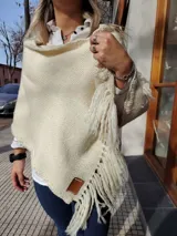 Chal color crema tejido a mano con flecos largos.