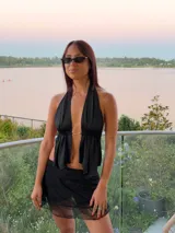 Minifalda de encaje negro con diseño semitransparente y short interno incorporado para mayor comodidad.