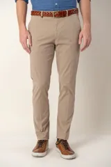 Pantalón de corte slim fit en color beige, confeccionado en algodón, con cierre frontal de botón y cremallera, y bolsillos laterales.