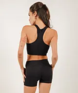 Top deportivo blanco de microfibra sin costuras, con sujeción media.