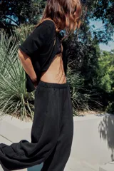 Pantalón de tiro medio con cintura elástica y pierna ancha. Presenta bolsillos laterales ocultos en la costura y un diseño fluido.