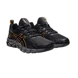 Championes de running Asics Gel-Quantum 180, color negro con detalles en dorado. Presentan tecnología de amortiguación GEL en la entresuela, diseño de malla transpirable y refuerzos sintéticos en los laterales con el logo de la marca.