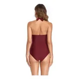 Malla entera de color verde oscuro, combinada con un diseño floreado en la parte inferior. Presenta escote halter cruzado y fruncidos en la zona del abdomen.