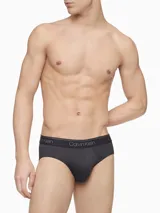 Pack de tres slips negros de microfibra stretch con cintura elástica con logo Calvin Klein.