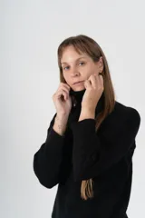 Sweater gris de tejido de punto, con cuello alto y mangas largas.