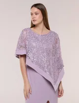 Vestido largo azul marino de seda fría, compuesto por una falda recta con tajo frontal y una capa superior superpuesta de encaje con lentejuelas bordadas, escote a la base y mangas tres cuartos acampanadas.