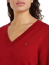Sweater de punto rojo con cuello en V y logo de Tommy Hilfiger bordado en el pecho.
