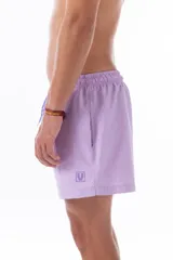 Short de baño lila de nylon con cintura elástica y cordón ajustable. Tiene bolsillos laterales y un bolsillo trasero con cierre.