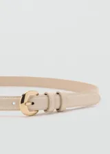 Cinturón fino de poliuretano color beige, con hebilla metálica dorada y doble presilla.
