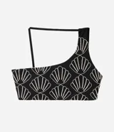 Top de bikini asimétrico de un solo hombro, color negro con bordado de conchas en tono claro, confeccionado en poliamida y elastano con forro de poliéster.