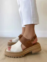 Sandalias de cuero color camel y crudo, con plataforma track y hebilla ajustable.