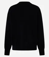 Buzo de tricot con cuello redondo y puños ajustados. Presenta un diseño de calce holgado y tejido de punto liso.
