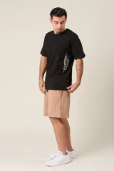 Bermuda de friza color gris melange, de corte suelto, con cintura elástica y cordón de ajuste negro.