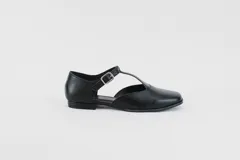 Zapato flat de cuero negro con tira central y hebilla lateral.