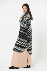 Tapado largo de lana con estampado zigzag horizontal en tonos grises y negros, de manga larga y abotonado.