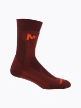 Pack de tres pares de medias técnicas largas para trekking, en colores beige, bordó y verde militar, con refuerzos acolchados y logo de la marca impreso en naranja.