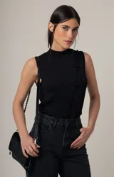 Top sin mangas de tejido de punto fino con acabado brillante, cuello alto y cierre frontal decorativo con nudos estilo oriental.