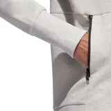 Campera deportiva Adidas con capucha, confeccionada en tejido spacer de color gris melange. Presenta cierre frontal completo, cordones ajustables en la capucha, bolsillos laterales con cierre y logo de la marca estampado en el hombro.