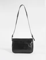 Bandolera de cuero vegano color verde oliva, con tapa frontal decorada con cuatro hebillas metálicas plateadas. Posee correa larga ajustable para llevar al hombro o cruzada.