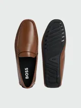 Mocasines de cuero color marrón claro con detalle de antifaz y logo grabado.