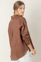 Camisa de lino color gris claro con bordado de monograma PEC en el bolsillo.