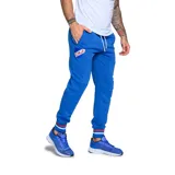 Pantalón de jogging azul marino con cintura elástica ajustable, bolsillos laterales con cierre y logo del Club Nacional de Football estampado en la pierna izquierda.