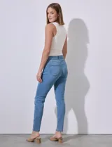 Jean elastizado de tiro medio, color celeste, con pretina con pasadores, cierre y botón metálico. Tres bolsillos en delantera y dos en parte trasera.