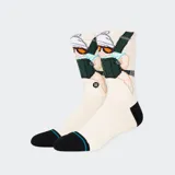 Medias Stance color crema con puño, talón y puntera negros. Diseño estampado con un personaje de caricatura esquiando.