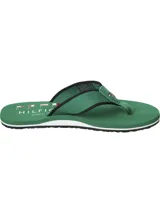 Ojotas Tommy Hilfiger verdes con suela blanca y tira de poliéster trenzado con logo de la marca.