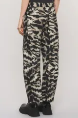 Pantalón de corte regular con estampado animal print tipo cebra en tonos negro y beige, bolsillos laterales y recortes con doble costura.
