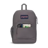 Mochila JanSport color gris, con un compartimento principal, bolsillo frontal con cierre, bolsillo lateral para botella de agua y sobre interno acolchado para laptop de 15 pulgadas.