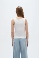Musculosa blanca de corte ajustado, con cuello redondo y diseño sin mangas.