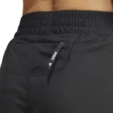 Short de running Adidas negro, tiro alto, con cintura elástica y cordón, confeccionado en tejido técnico 100% poliéster reciclado. Posee bolsillos laterales con cremallera y un bolsillo trasero con cremallera para el móvil.