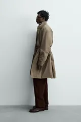 Parka relaxed fit de tejido técnico ligero, color verde militar, con cuello subido, manga larga y bolsillos de plastrón con solapa en la cadera. Cuenta con cintura ajustable con cordones y cierre frontal con cremallera oculta por solapa con botones a presión.