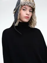 Sweater de cuello polera con hombros caídos y diseño de calce holgado. Presenta terminaciones acanaladas en puños y ruedo, confeccionado en tejido de punto suave.