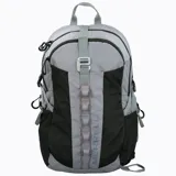 Mochila técnica de 22 litros marca Merrell, diseñada para actividades outdoor. Presenta un diseño bicolor en gris y negro, con múltiples compartimentos, bolsillos laterales para botellas, respaldo acolchado con malla transpirable, cinta frontal tipo daisy chain para accesorios y correas ajustables con silbato de emergencia.