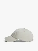 Gorra de seis paneles color beige claro, confeccionada en algodón orgánico, con visera curva y logo bordado de Tommy Jeans en el frente.