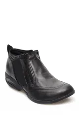 Botin de cuero negro con cierre lateral, paneles elásticos y suela con tecnología de amortiguación de aire en el talón.