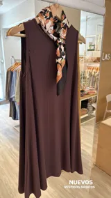 Vestido corto sin mangas, color marrón oscuro, confeccionado en tejido de punto acanalado (morley). Presenta un corte amplio y fluido.