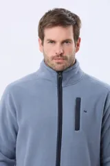 Campera polar térmica de corte recto y cuello alto, con cierre frontal completo en contraste. Presenta bolsillos laterales con cierre y un bolsillo vertical en el pecho, todos con detalles en color azul marino.