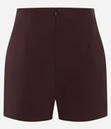 Short pollera corto color marrón de bengalina, con diseño cruzado en el frente, cierre invisible en la parte trasera y talle alto.