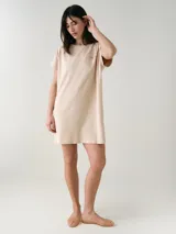 Camisón blanco de algodón, de corte holgado, manga corta y largo por encima de las rodillas. Presenta una pequeña estampa localizada en el pecho y aberturas en los laterales.