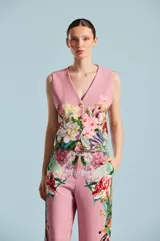 Chaleco sastre color rosado, con escote en V, sin mangas, cierre frontal con botones y estampado floral multicolor.