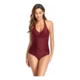 Malla entera de color verde oscuro, combinada con un diseño floreado en la parte inferior. Presenta escote halter cruzado y fruncidos en la zona del abdomen.